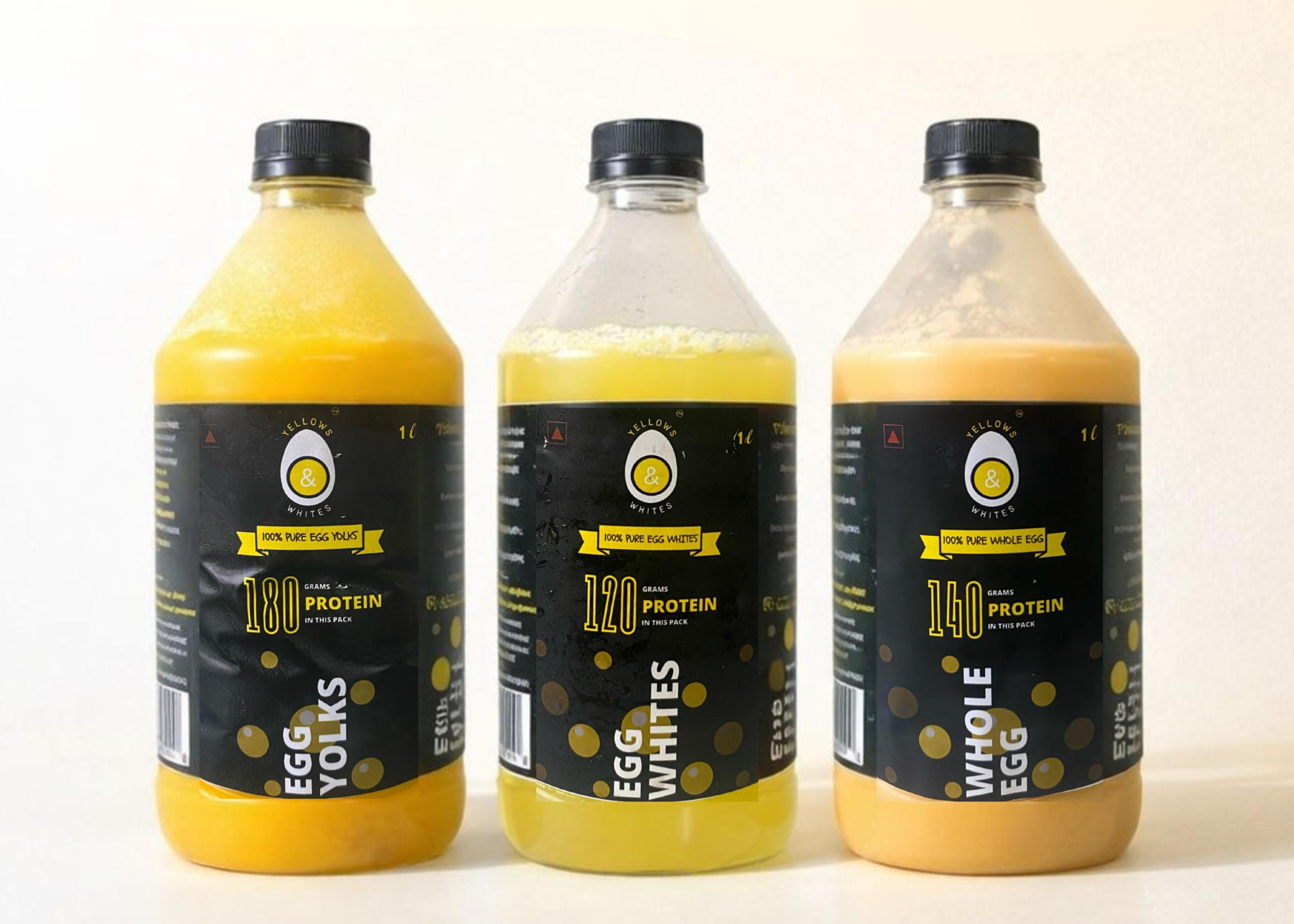 Three bottles of liquid pasteurized eggs labeled 'Egg Yolks', 'Egg Whites', and 'Whole Egg' on a white background.